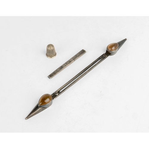 570 - A KNITTING NEEDLE HOLDER SET WITH CABACHON AGATES Together with an engraved needle case and a silver... 