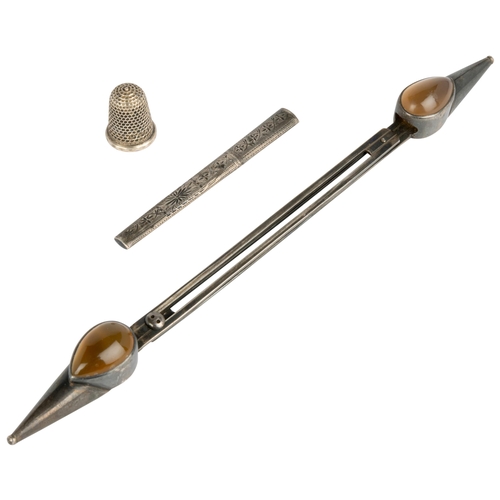 570 - A KNITTING NEEDLE HOLDER SET WITH CABACHON AGATES Together with an engraved needle case and a silver... 