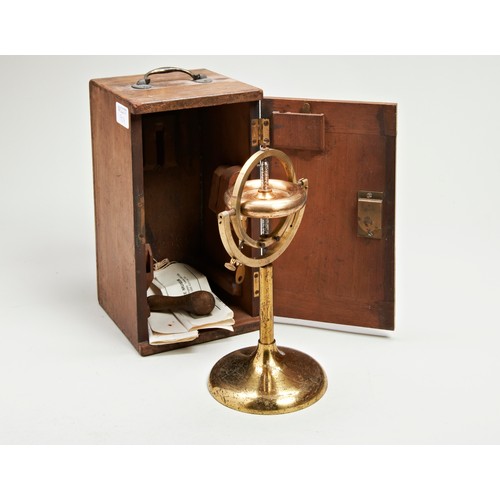 1457 - A VICTORIAN GRAVITATIONAL BRASS GYROSCOPE IN A MAHOGANY CASE.23 cms high