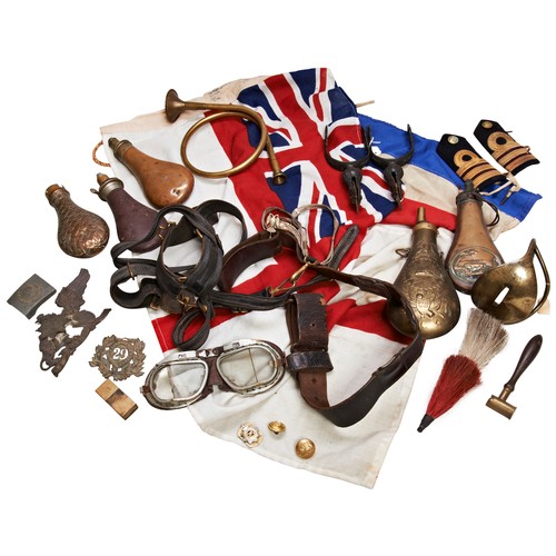 662 - A PAIR OF ORNATE PATINATED STIRRUPS WITH STEEL ROWELS, AN ENSIGN FLAG, ANOTHER FLAG AND OTHER ITEMS.