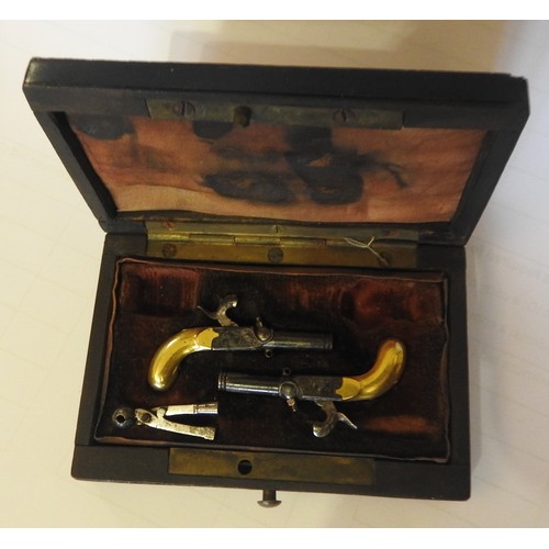 631 - A CASED 19TH CENTURY PAIR OF MINIATURE PERCUSSION PISTOLS with engraved decoration, drop down trigge... 