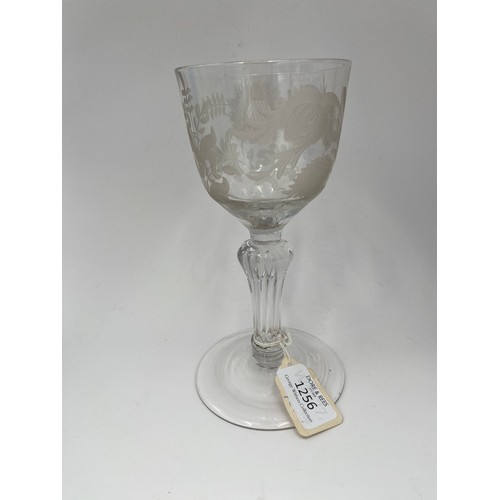 1256 - AN ENGRAVED 18TH CENTURY WINE GLASSCirca 1750, the engraved bowl raised on a faceted stem, 19cms hig... 