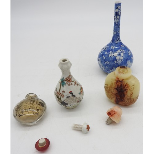 293 - THREE CHINESE SNUFF BOTTLES AND A BOTTLE VASE, the lot includes a garlic mouth snuff bottle, a rever... 