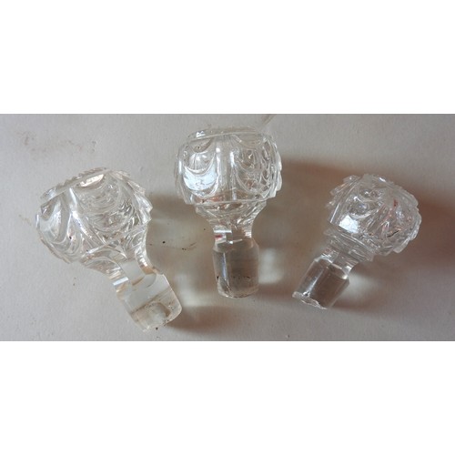 295 - A PAIR OF VICTORIAN CUT GLASS DECANTERS AND SIMILAR DECANTER, tapering baluster form with ribbed nec... 