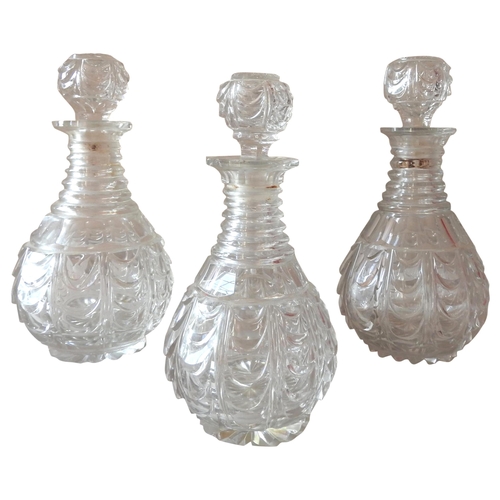 295 - A PAIR OF VICTORIAN CUT GLASS DECANTERS AND SIMILAR DECANTER, tapering baluster form with ribbed nec... 