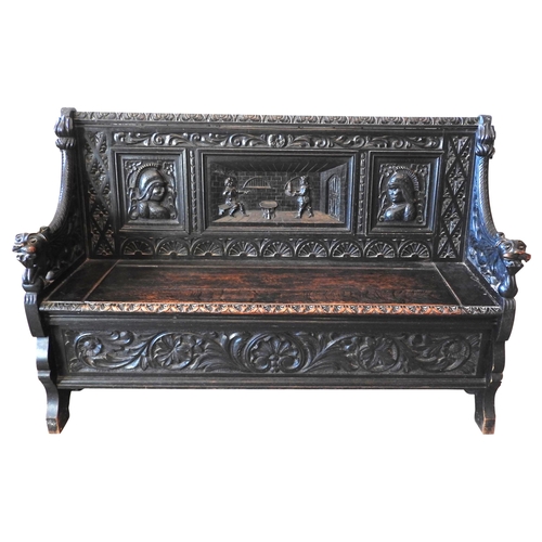 106 - A CARVED OAK SETTLE, LATE 19TH CENTURY, the low back panel carved with a central tavern scene panel ... 