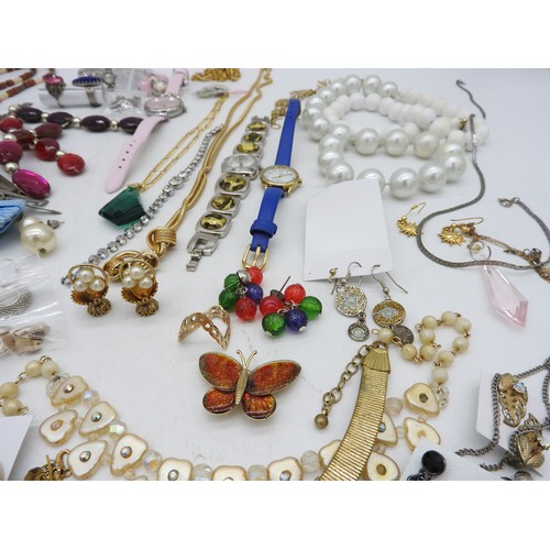 568 - A SELECTION OF COSTUME JEWELLERY, including bead necklaces, pendants, earrings, brooches and four wr... 