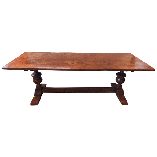 83 - AN 18TH CENTURY OAK REFECTORY TABLE, the two plank rectangular top raised on baluster turned end sup... 