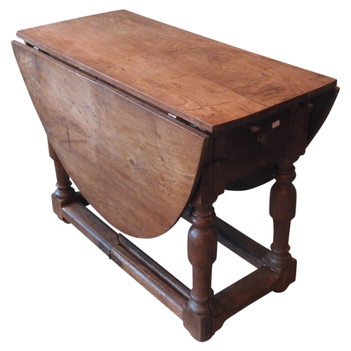 86 - AN EARLY 18TH CENTURY CONTINENTAL OAK GATE-LEG TABLE, hinged oval top over a single end frieze drawe... 