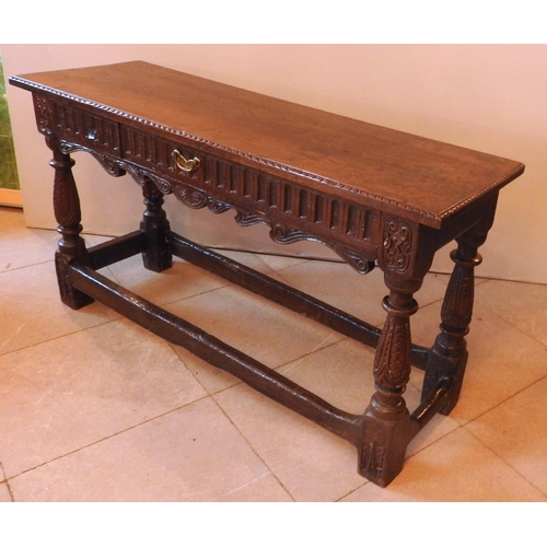 93 - AN 17TH CENTURY CHARLES II OAK HALL TABLE, with a long linen carved frieze drawer above a scroll car... 