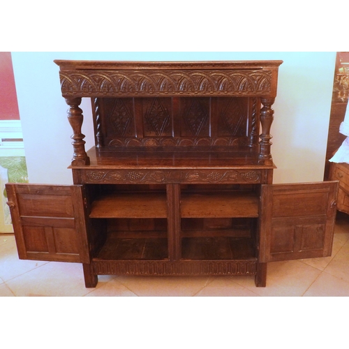 95 - A CHARLES II OAK COURT CUPBOARD, CIRCA 1680, in two sections, the top section with heavily carved lo... 