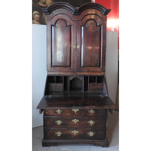 58 - A GEORGE III OAK BUREAU BOOKCASE, in two sections, the associated twin arch top section surmounted w... 