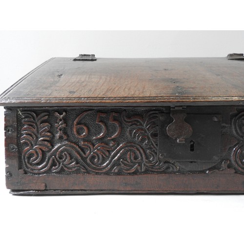 97 - A CHARLES II OAK BIBLE BOX, CIRCA 1655, the frieze panel carved with scroll foliate decoration and t... 