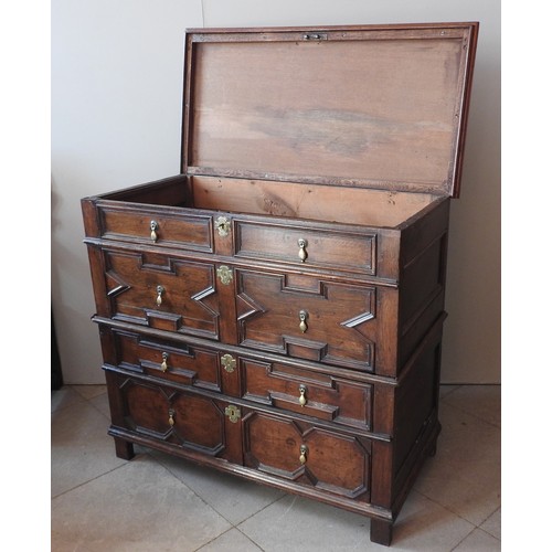 98 - AN 18TH CENTURY OAK CHEST OF DRAWERS, in two sections, with a moulded edge hinged rectangular top ov... 