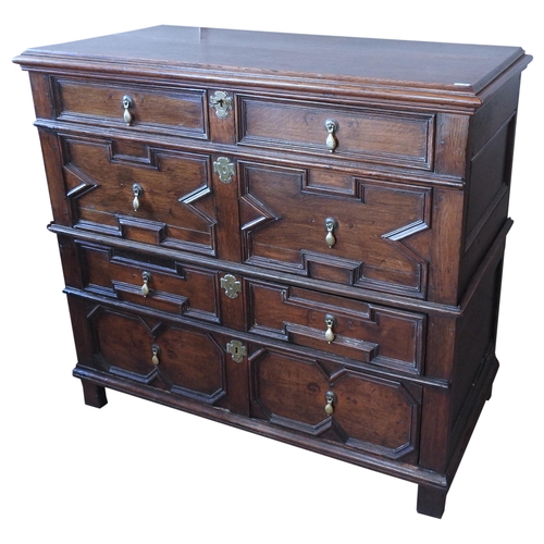 98 - AN 18TH CENTURY OAK CHEST OF DRAWERS, in two sections, with a moulded edge hinged rectangular top ov... 