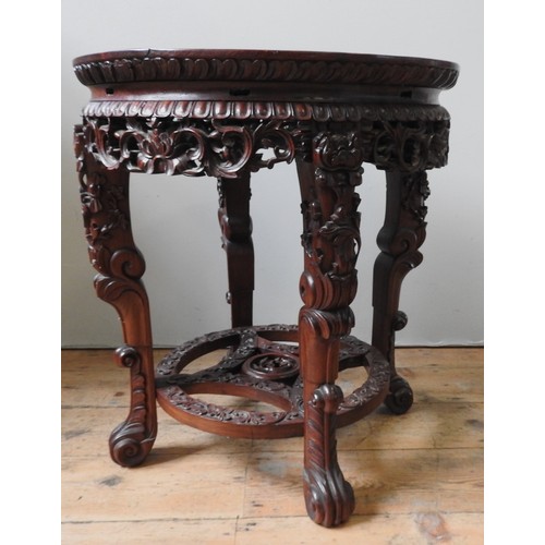 109 - AN ORNATE CHINESE HARDWOOD STAND, 20TH CENTURY, circular lotus form top inset with biege marble pane... 