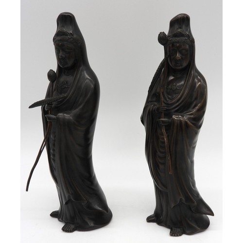 272 - TWO CHINESE BRONZE FIGURES OF GUANYIN, both modelled standing in flowing robes, each clutching a lot... 