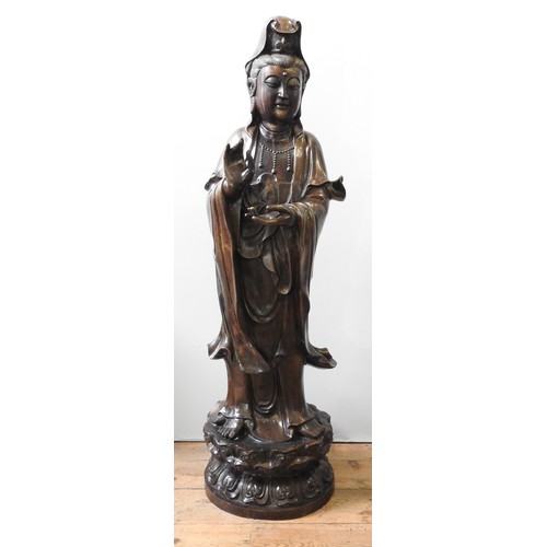 492 - A LARGE CAST BRONZE GUANYIN FIGURE, modelled in a standing traditional pose with flowing robes, the ... 