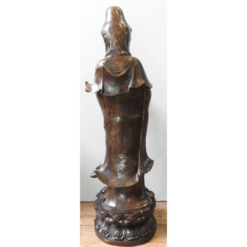 492 - A LARGE CAST BRONZE GUANYIN FIGURE, modelled in a standing traditional pose with flowing robes, the ... 