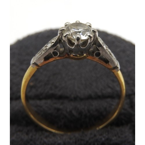 588 - A SOLITAIRE DIAMOND RING, the brilliant cut 0.5 ct diamond flanked by shoulders set with four diamon... 