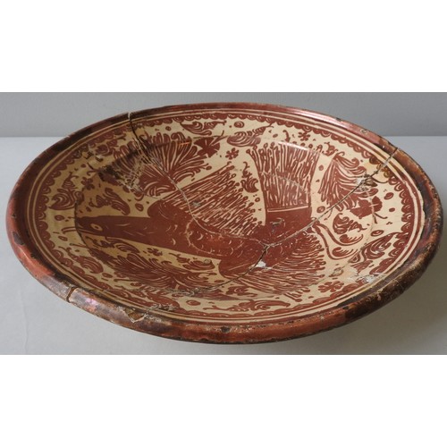 359 - A HISPANO MORESQUE CHARGER/BASIN DECORATED IN COPPER LUSTRE WITH AN EAGLE, 17TH/18TH CENTURY, broken... 