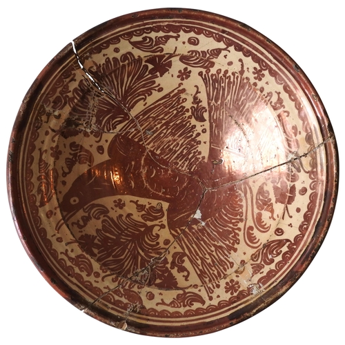 359 - A HISPANO MORESQUE CHARGER/BASIN DECORATED IN COPPER LUSTRE WITH AN EAGLE, 17TH/18TH CENTURY, broken... 