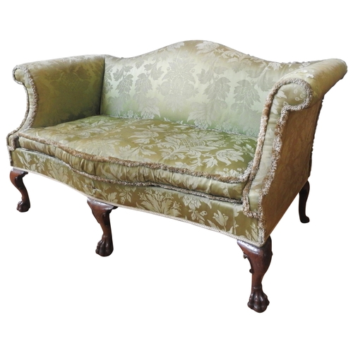 74 - A GEORGE III CAMEL BACK SETTEE, CIRCA 1800, with scrolling arms, raised on carved paw foot cabriolet... 