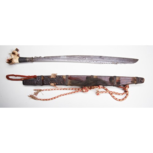 211 - A GOOD DAYAK MANDAU SWORD the fine deer antler hilt with coloured fibre tufts the forged iron blade ... 