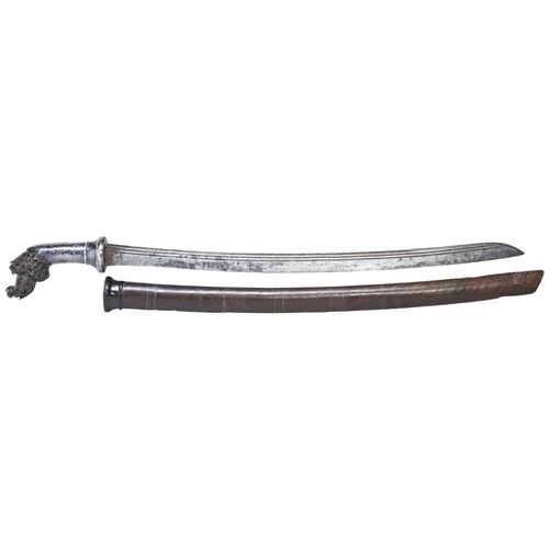 213 - A LUWUK SWORD  the intricately carved hilt with silver niello foliate decorated grip the ribbed stee... 