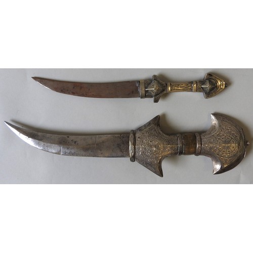 205 - A LARGE AND ORNATE JAMBIYA WITH WHITE METAL HILT AND CURVED SCABBARD AND ANOTHER JAMBIYA.45 cms max... 