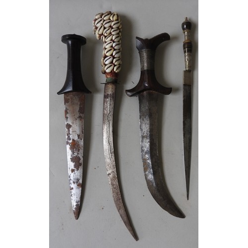 206 - A NORTH AFRICAN JAMBIYA WITH TOOLED LEATHER SCABBARD, A NORTH AFRICAN DAGGER WITH COWRIE SHELL DECOR... 