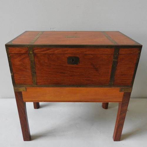 474 - A SATINWOOD BRASS BOUND WRITING SLOPE with lower drawer and mounted on a later low wooden stand. 50 ... 