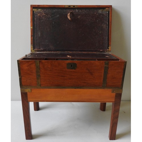 474 - A SATINWOOD BRASS BOUND WRITING SLOPE with lower drawer and mounted on a later low wooden stand. 50 ... 