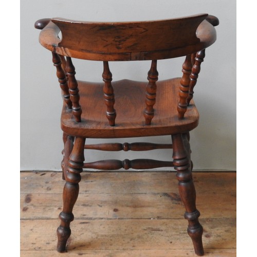 41 - A LATE 18TH/EARLY 19TH CENTURY SMOKER'S BOW CHAIR, with scrolling back support, the elm saddle seat ... 