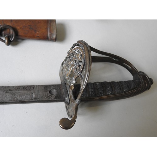 195 - A NAVAL OFFICERS SWORD WITH LIONS HEAD POMMEL and shagreen wired grip the heavily oiled blade with e... 