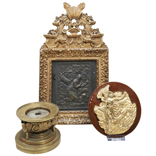 638 - A POLISHED BRONZE INKWELL SUPPORTED BY THREE WINGED LIONS, missing lid, a gilt brass plaque and a re... 