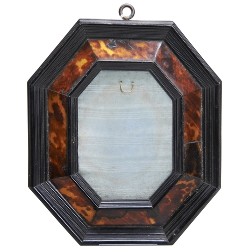 658 - AN OCTAGONAL TORTOISESHELL VENEERED FRAME, probably 17th century the ebonised moulded frame with slo... 