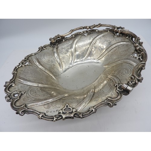 557 - A GOOD VICTORIAN SILVER SWING-HANDLED BASKET; of ornate compartmental form on a raised foot, hallmar... 