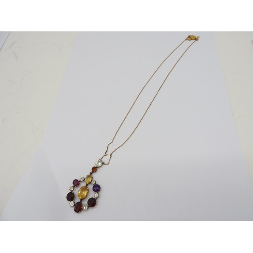 521 - AN EDWARDIAN GEM SET YELLOW METAL PENDANT set with amethyst, quartz and garnet. Chain broken.