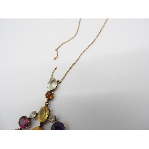 521 - AN EDWARDIAN GEM SET YELLOW METAL PENDANT set with amethyst, quartz and garnet. Chain broken.