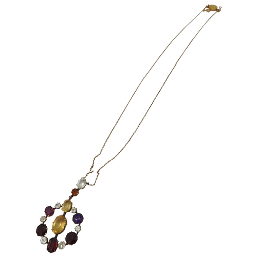 521 - AN EDWARDIAN GEM SET YELLOW METAL PENDANT set with amethyst, quartz and garnet. Chain broken.