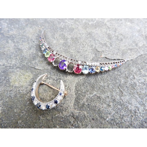 534 - A SMALL DIAMOND AND SAPPHIRE CRESCENT SHAPED BROOCH set in yellow and white metal and a multi gem se... 