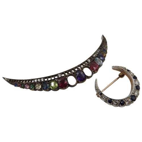 534 - A SMALL DIAMOND AND SAPPHIRE CRESCENT SHAPED BROOCH set in yellow and white metal and a multi gem se... 