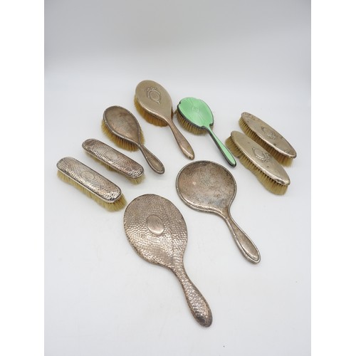 524 - A GROUP OF TWO SILVER HAND MIRRORS AND SEVEN SILVER MOUNTED BRUSHES, various styles including an ena... 