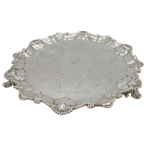 552 - A VICTORIAN SILVER SALVER, with scrolling shell embellished rim and chased rocaille decoration with ... 