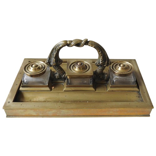 498 - AN IMPRESSIVE LARGE BRASS INKSTAND, LATE 19TH CENTURY, the rectangular form stand with three glass i... 