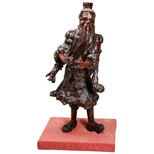 693 - AN EXCEPTIONALLY LARGE CARVED ROOT WOOD FIGUREQING DYNASTY, 19TH CENTURYthe standing figure modelled... 