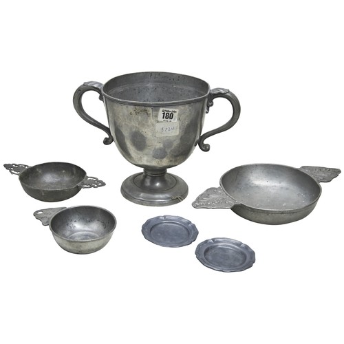 152 - A LARGE PEWTER PORRINGER, two others, a pewter two handled cup emblazoned with an arms and two small... 