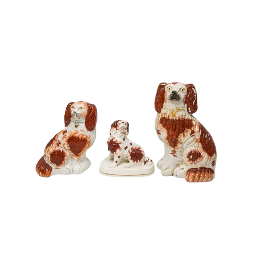 267 - A PAIR OF STAFFORDSHIRE CATTLE DECORATED SPILL VASES AND THREE SPANIEL FIGURES, 19TH CENTURY, the sp... 