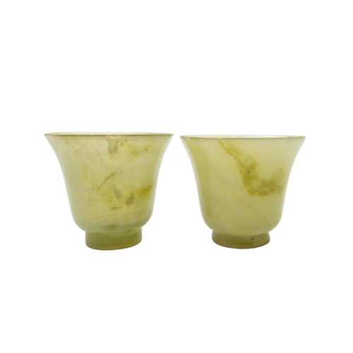 194 - A FINE PAIR OF CHINESE CELADON AND RUSSETT JADE WINE CUPS5 cm high x 6 cm diam